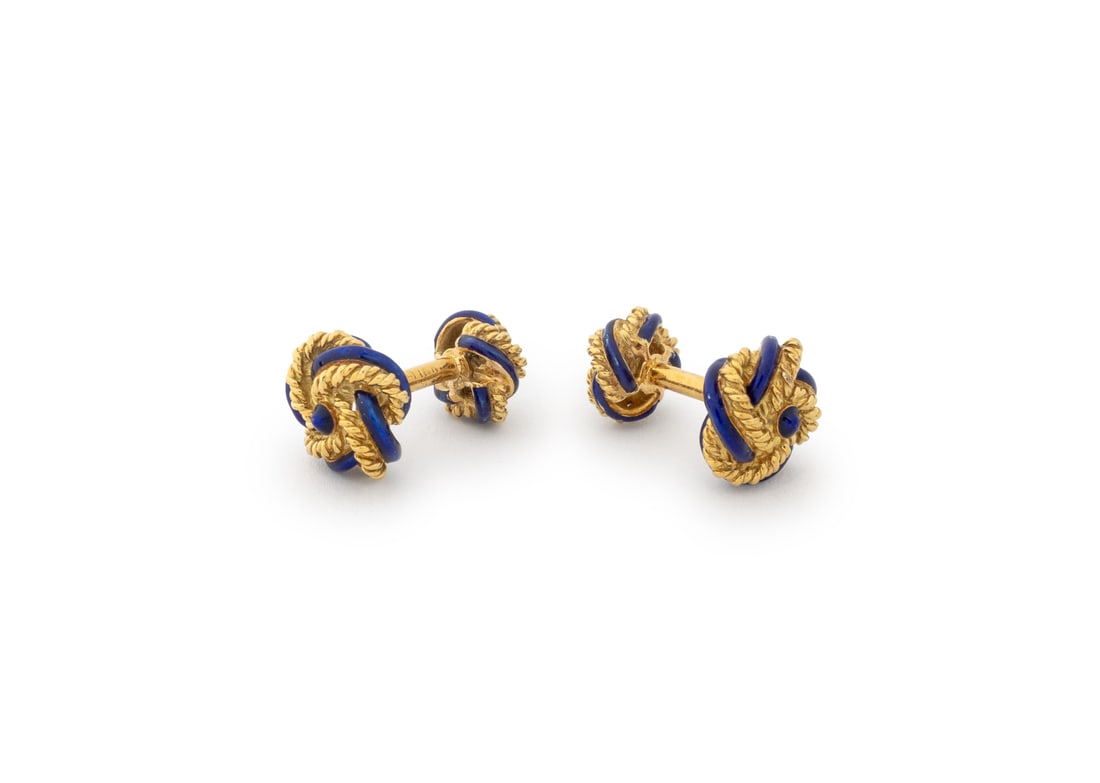 Knot Motif Blue Enameled Yellow Gold Cufflinks: Knot Motif Blue Enameled 18K Yellow Gold Cufflinks, designed as twisted wire rope knots decorated with applied cobalt enamel, worn through French cuffs with fixed posts and backs, marked: "18K". Measu