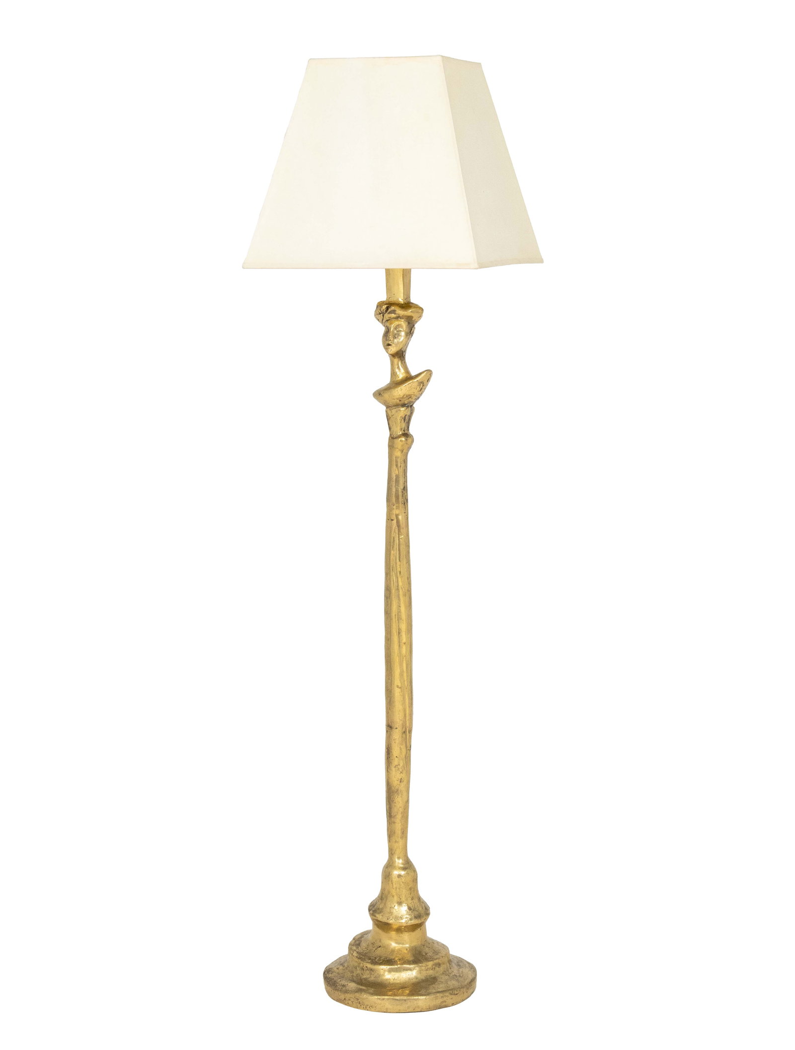 After Alberto Giacometti Tete de Femme Floor Lamp: After Alberto Giacometti "Tete de Femme" Floor Lamp, gilt bronze base with white paper shade. 64.75" H x 16" W x 16.25" D. Provenance: From an Upper East Side Townhouse. Keywords: Sculptural lamp, Sta