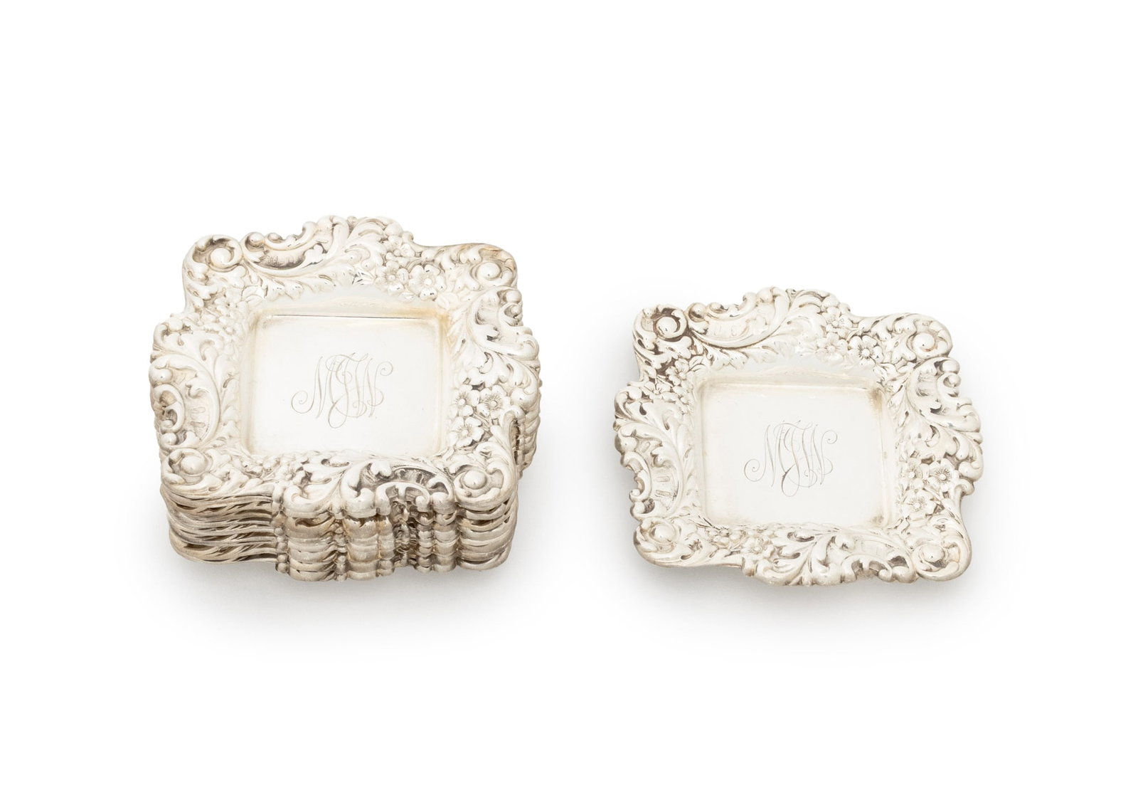 Shreve & Co. Sterling Silver Nut Dishes, 12: Set of 12 Shreve and Company Sterling Silver Repousse Nut Dishes, monogrammed "MLW" and marked "Shreve & Co. / San Francisco / Sterling" to underside. Weight: 6.92 ozt.; 3.25" H x 3" W. Provenance: