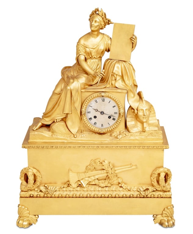 Charles X Gilt Bronze Figural Mantel Clock: Charles X Gilt Bronze Figural Mantel Clock, circa 1830, the silvered dial with strike on bell movement, surmounted by a seated figure of Cleopatra writing to Mark Anthony, on a rectangular base mounte