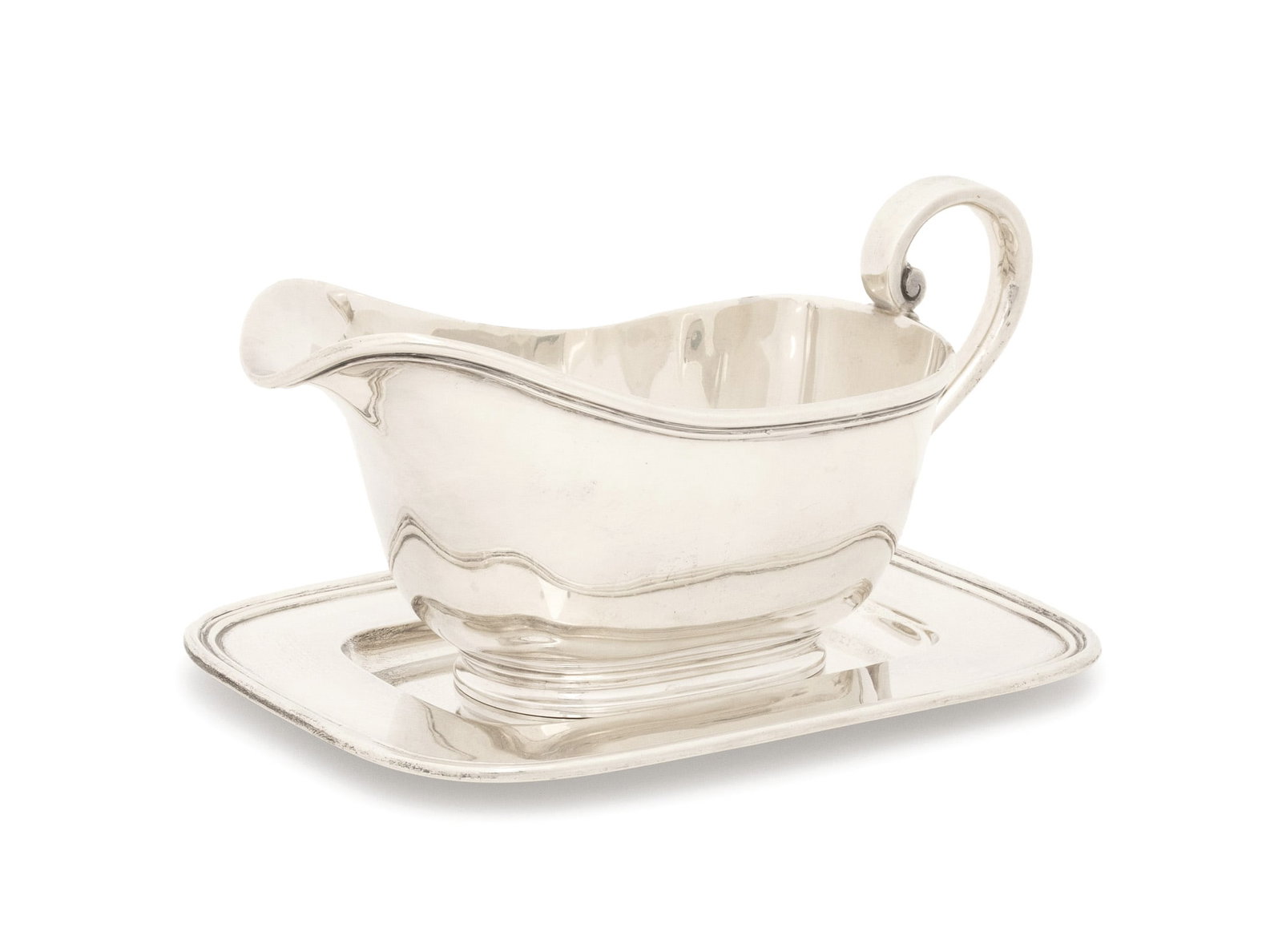 Tiffany & Co. Makers Sterling Gravy Boat & Saucer: Tiffany and Company Makers Sterling Silver Sauce Boat and Saucer, 1956-1965, each marked to underside. Weight: 21.98 ozt.; 4.5" H x 8.25" W x 6" D. Provenance: From a 500 Park Avenue Estate. Keywords: