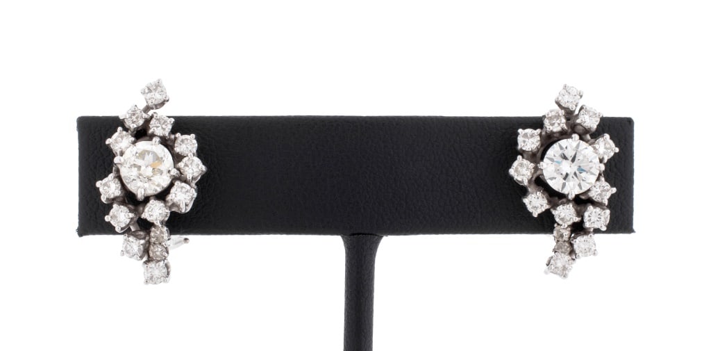 Vintage Diamond Cluster and Platinum Earrings: Pair of Vintage Diamond Cluster and Platinum Earrings, adorned with two centered centered round faceted diamonds, weighing a total of approx. 1.85 carats, I-K color VS-SI clarity, further adorned with