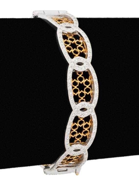 Charriol 18K Two-Tone Gold and Diamond Bangle: Charriol 18K Two-Tone and Diamond Bangle, brightly polished, framed in white gold with yellow gold openwork lattice, adorned with 94 pave set round brilliant cut diamonds weighing a total of approx. 1
