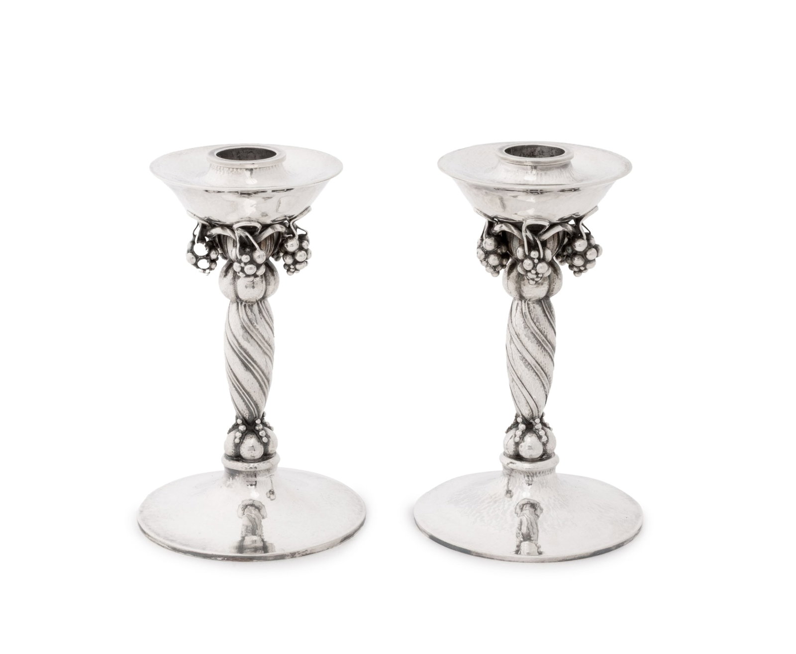 Georg Jensen Sterling Silver Candlesticks, Pair: Pair of Georg Jensen Sterling Silver Grapevine Motif Candlestick Holders, no. 263, marked to undersides. Weight: 22.88 ozt.; 6" H x 3.25" Diameter. Provenance: From a 500 Park Avenue Estate. Keywords: