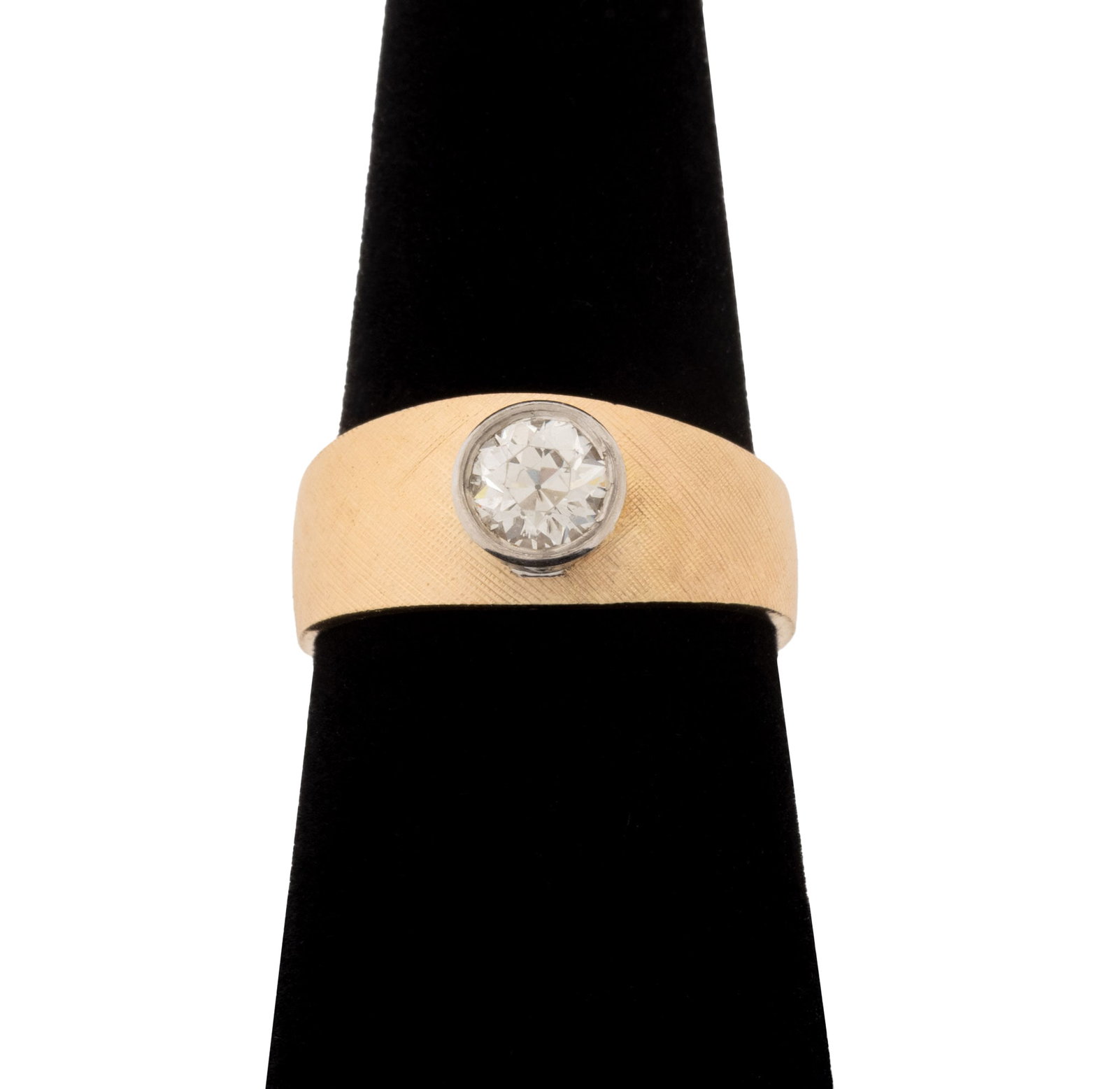Modernist Two-Tone Gold and Diamond Ring: Modernist 14K Yellow Gold and White Gold Diamond Ring, featuring one white gold bezel set round round faceted diamond weighing approx. 0.80 carat, I-J color / SI2 clarity, yellow gold shank decorated 