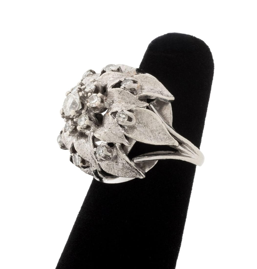 Floriform White Gold and Diamond Cluster Ring: Flower Form 14K White Gold and Diamond Cluster Ring, featuring fifteen prong set round faceted diamonds weighing a total of approx.1.35 carats. Gold tested. Measuring approx. US size 4, 3/4" x 3/4", 6
