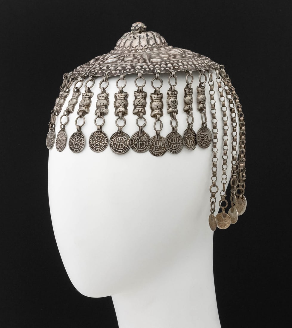 Ottoman Empire Silver Coin Mounted Hat Adornment: Ottoman Empire Silver Coin Mounted Hat Adornment, surmounted by a red coral cabochon. Weight: 8.10 ozt. inclusive; 7.75" H x 6" Diameter. Provenance: From the Estate of Jewelry Designer Irena Corwin. 