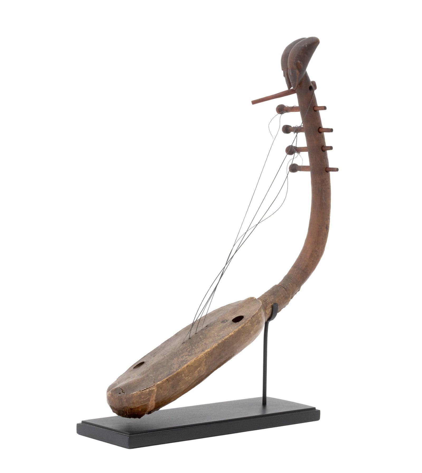 African Mangbetu Domu Harp: African Mangbetu Domu Harp, Democratic Republic of the Congo, early 20th century or earlier, the carved wood headstock in the form of twin heads, the body covered in rawhide, with a fitted stand. Over