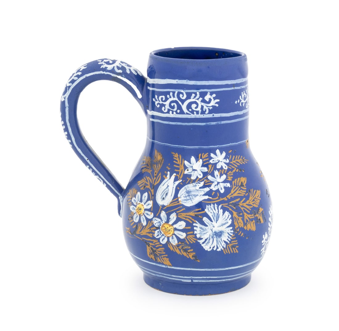 Nevers French Faience Jug, 18th C.: Nevers French Faience Jug, 18th century or earlier, hand-painted with white flowers on a Persian blue ground, old chalk marks to underside. 8.25" H x 7.5" W x 5" D. Provenance: From the Estate of Gera