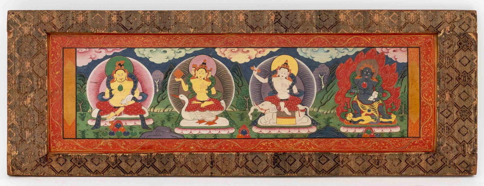 Tibetan Sutra Illumination: Tibetan Sutra Illumination, Gouache on Paper, depicting Yellow Zambhala and the three protectors, mounted in silk wrapped wood frame. Image: 6.5" H x 21.5" W; frame: 9.25" H x 26" W x 1" D. Provenance