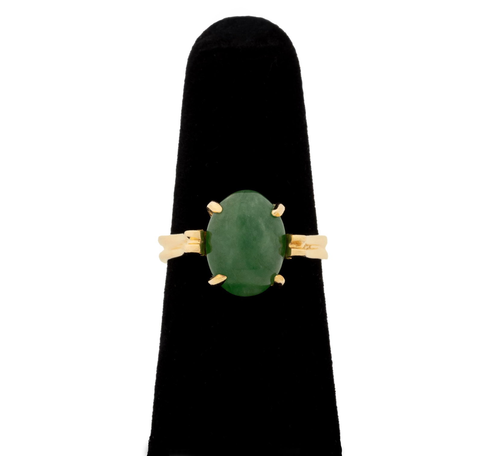 Spinach Jade and Yellow Gold Solitaire Ring: 14K Yellow Gold and Spinach Jade Solitaire Ring, featuring one prong set oval jade cabochon weighing approx. 4.50 carats, metal surfaces brightly polished and designed as double shank ring. Gold teste