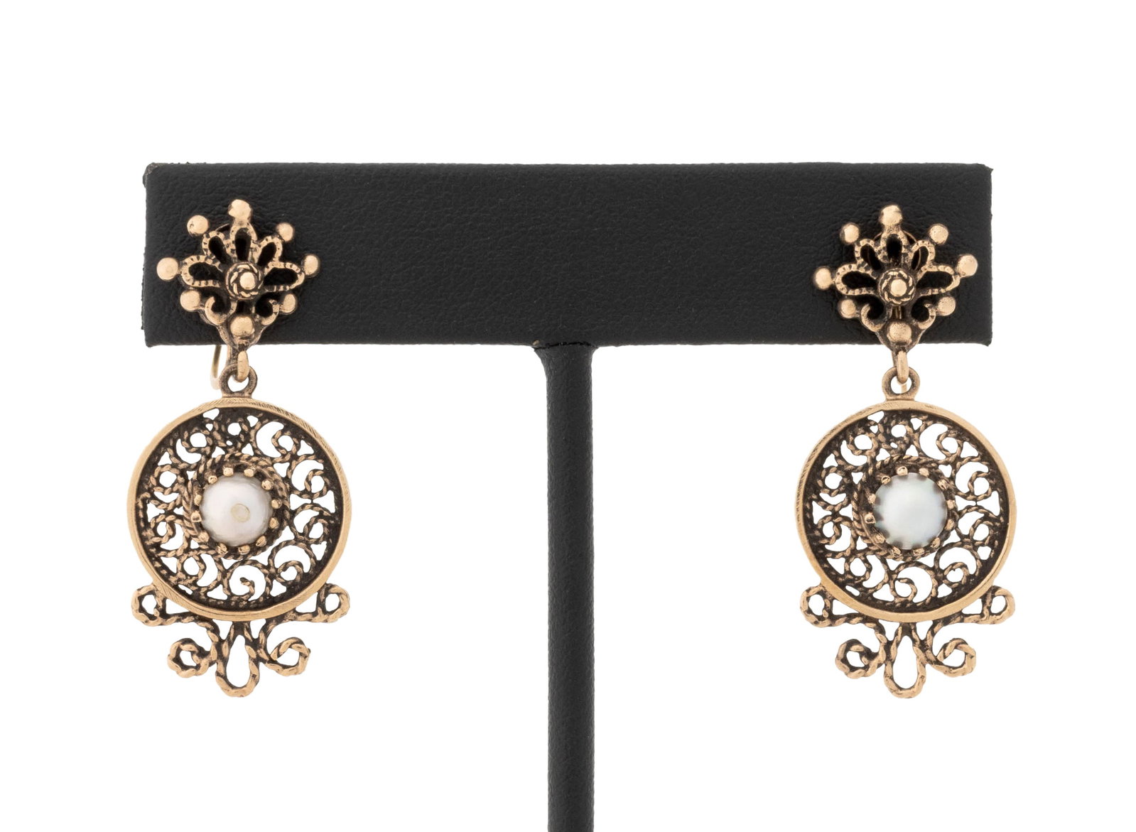 Yellow Gold and Cultured Pearl Pendant Earrings: 14K Yellow Gold and Cultured Pearl Pendant Earrings, featuring two prong set round cultured pearls approx. 5.0 - 5.5 mm., decorated with filigree open work and brightly polished surfaces, worn on earl