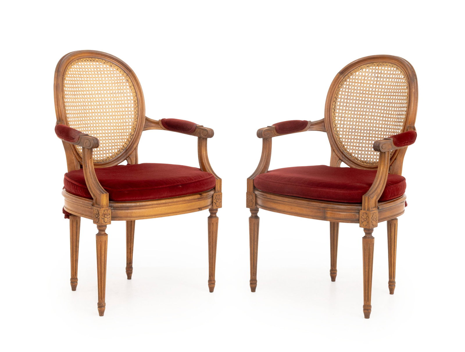 Louis XVI Style Red Velvet & Walnut Fauteuils, Pr.: Pair of Louis XVI Style Red Velvet Upholstered Cane-Paneled Walnut Fauteuils, each with removable cushion above fluted legs. 37" H x 24" W x 22" D; seat: 19" H (with cushion); armrest: 26.5" H. Proven