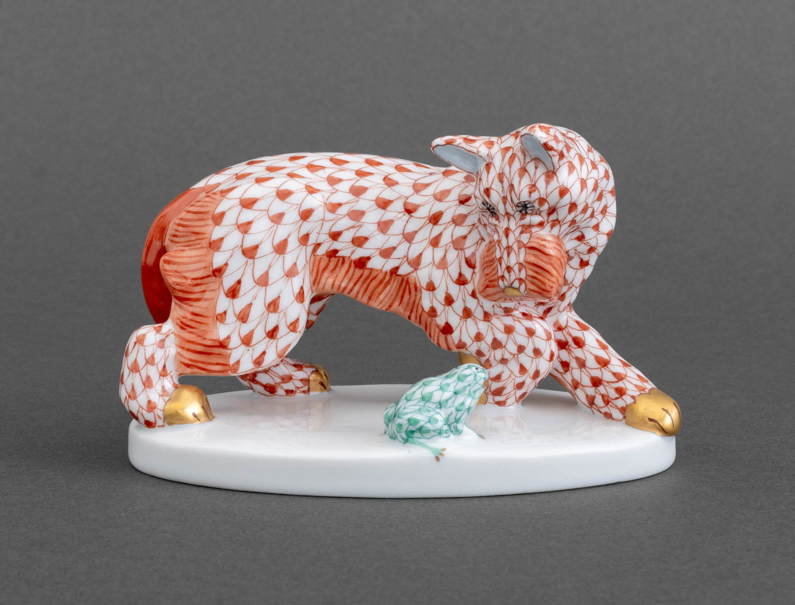 Herend Dog & Frog Red Fishnet Porcelain Figurine: Herend Red Fishnet Porcelain Scottie Dog and Frog Figurine, with hand-painted and gilt accents on oval base, marked "Herend / Hungary / Handpainted / 5323 / VH" to underside. 3" H x 4.25" W x 2.75"