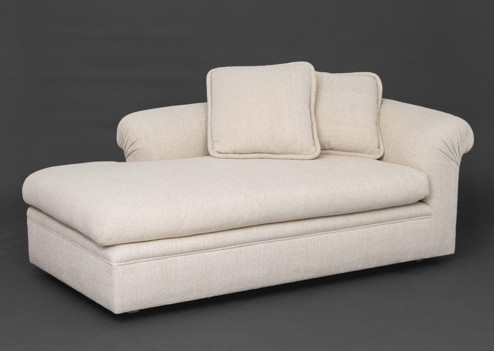 Modern Beige Upholstered Chaise Longue: Modern Beige Textured Fabric Upholstered Chaise Longue, together with two matching pillows. 28" H x 77" W x 39" D; seat: 21" H. Provenance: From a 500 Park Avenue Estate. Keywords: Modern Furniture,
