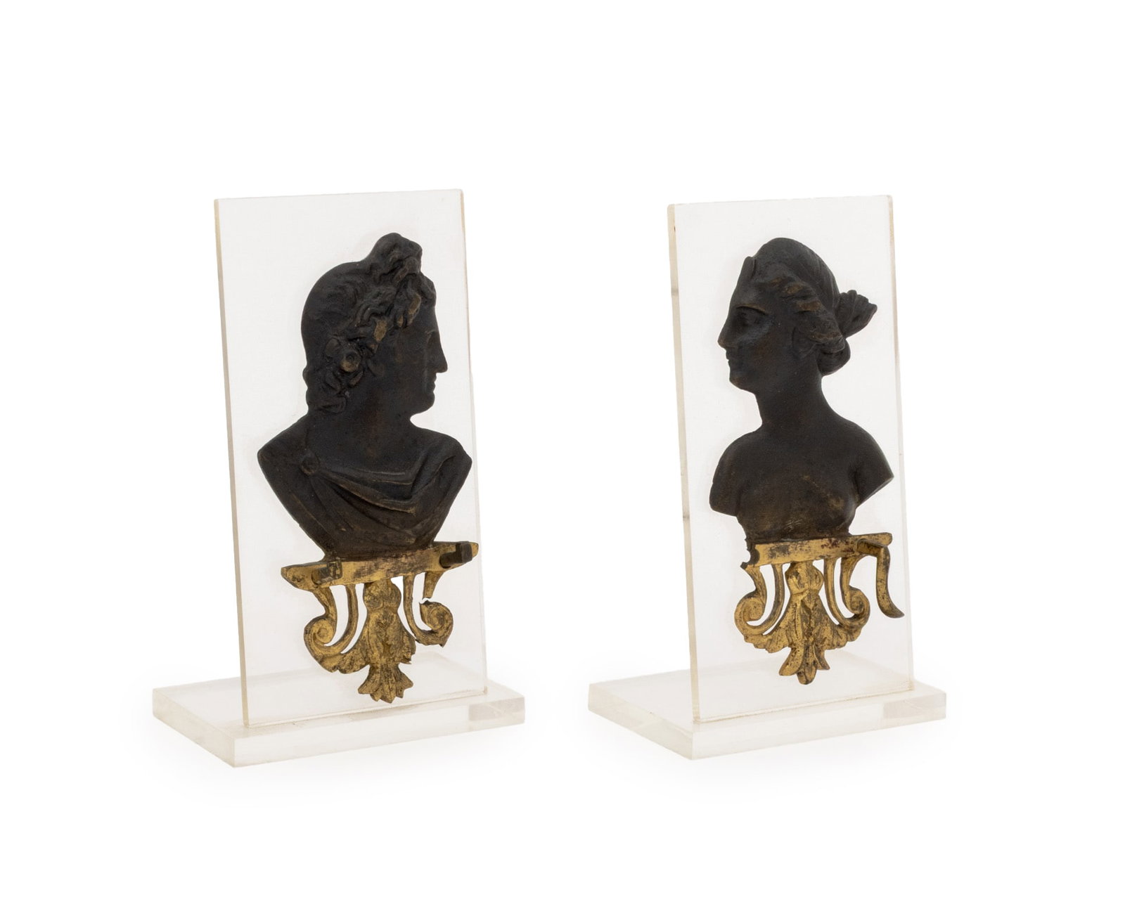 Grand Tour Mounted Bronze Portrait Busts, Pair: Pair of Grand Tour Mounted Bronze Portrait Busts, patinated bronze relief busts of Apollo and Artemis atop gilt filigree, mounted on clear acrylic bases. 5" H x 3" W x 1.75" D. Provenance: From the Es
