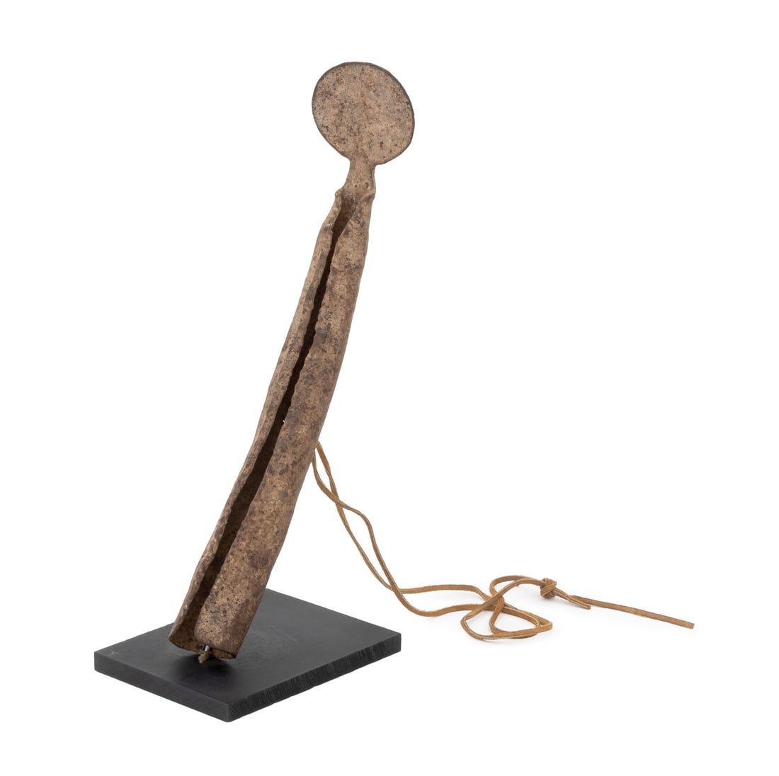 West African Senufo Hand-Forged Iron Rasp Gong: West African Senufo Hand-Forged Iron Rasp Gong, with tan leather strap mounted on ebonized wood base. Overall: 14.25" H x 4.75" W x 8.75" D. Provenance: From an Upper West Side Estate. Keywords: Music