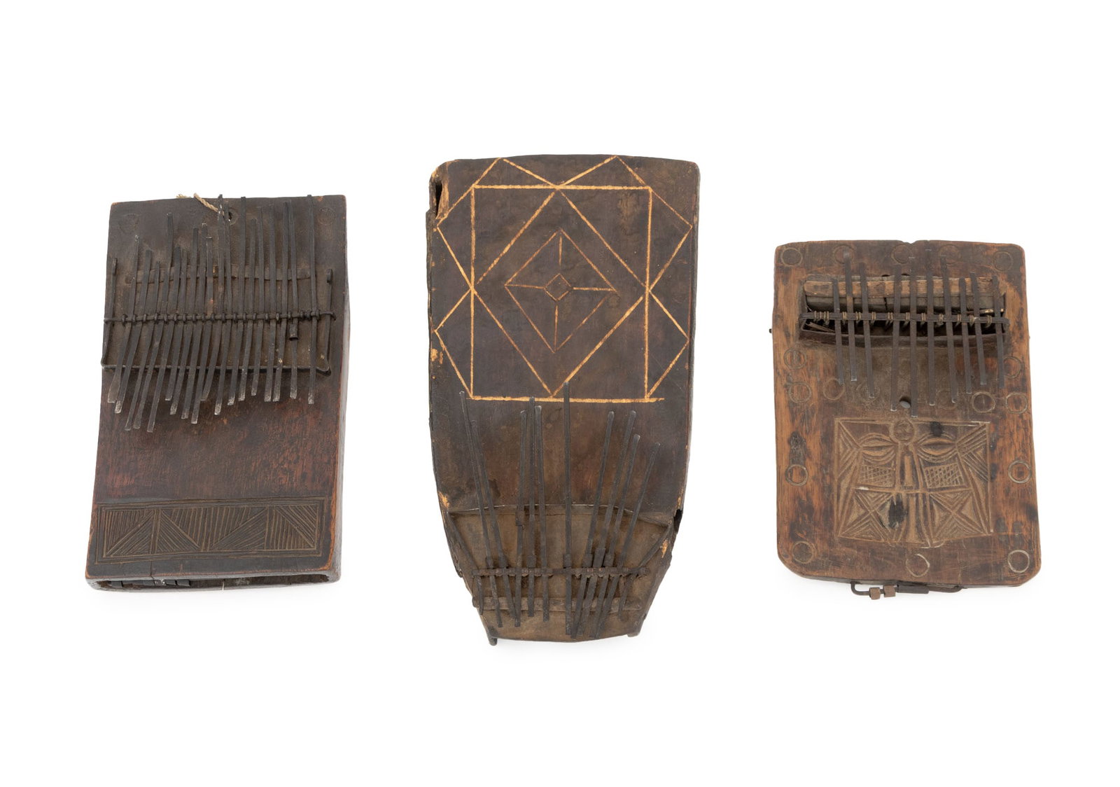 West African Carved Wood Sansas, 3: Collection of Three West African Carved Wood Sansas, each with metal keys and geometric carved motif. Largest: 11.5" H x 6" W x 2" D. Provenance: From an Upper West Side Estate. Keywords: Musical Inst