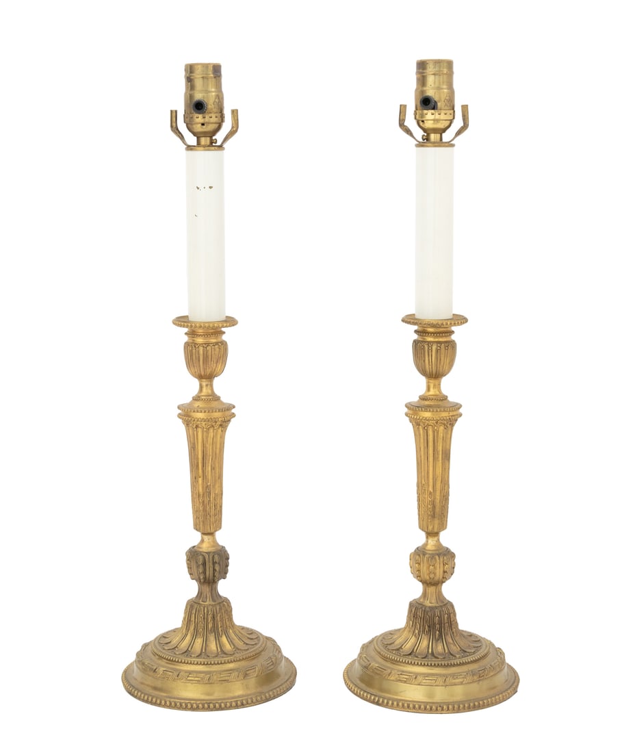 Louis XVI Style Gilt Brass Candlestick Lamps, Pair: Pair of Louis XVI Style Gilt Brass Candlestick Lamps, each with fluted column above circular base with beaded rim. 21.25" H x 6" Diameter. Provenance: From an East 79th Street Estate. Keywords: French