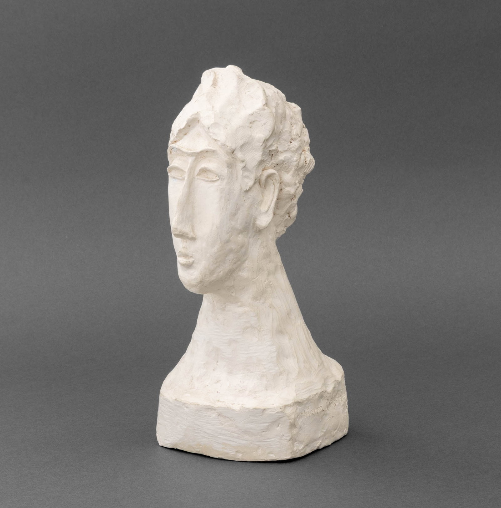 Marion Rothenberg Bust of a Man Plaster Sculpture: Marion Rothenberg (American, 1923-2025) Bust of a Man Plaster Sculpture, signed to side of base. 10.5" H x 4.75" W x 4.5" D. Provenance: The Morningside Heights Estate of an Academic. Keywords: Statue