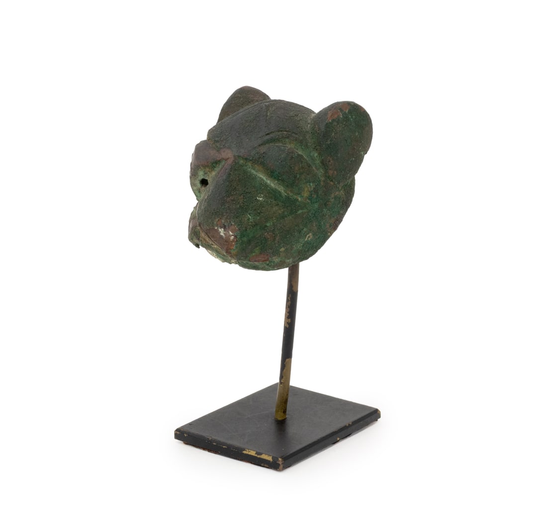 Seljuk Empire Lion Head Bronze Sculpture: Seljuk Empire Lion Head Bronze Sculpture,12th century, on metal stand, with paper label underside. Sculpture: 2" H x 1.5" W x 1.25" D; overall: 3.75" H x 1" W x 2" D. Provenance: From the Estate of Ge