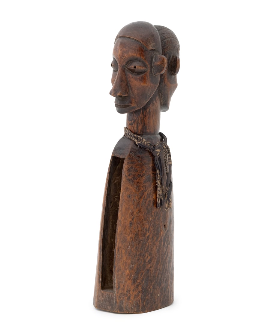 African Yaka Double-Headed Slit Drum: African Yaka Double-Headed Slit Drum, Democratic Republic of the Congo, hand-carved wood with textile around neck, paper label reading "32233" to underside. 14.75" H x 4.75" W x 3.75" D. Provenance: