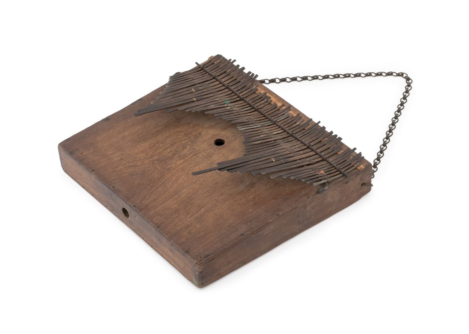 East African Ilimba Lamellophone: East African Ilimba Lamellophone, probably Tanzania, carved wood box with 51 metal keys and metal chain strap. 4.25" H x 13.75" W x 13" D. Provenance: From an Upper West Side Estate. Keywords: