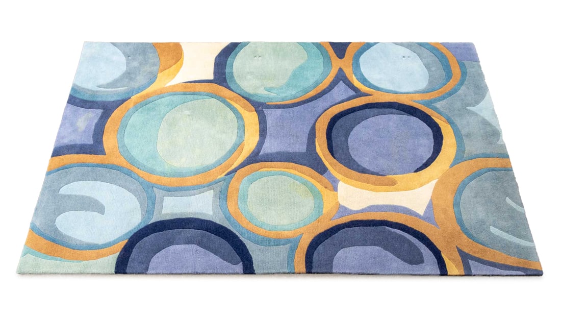 Momeni Blue New Wave Rug, 8' x 5' 2": Momeni Blue New Wave Wool Rug, with circular pattern, "Momeni" label to underside. 8' L x 5' 2" W. Provenance: From an East Village Estate. Keywords: Carpets, Area rug, Floor covering, Textiles, Furni