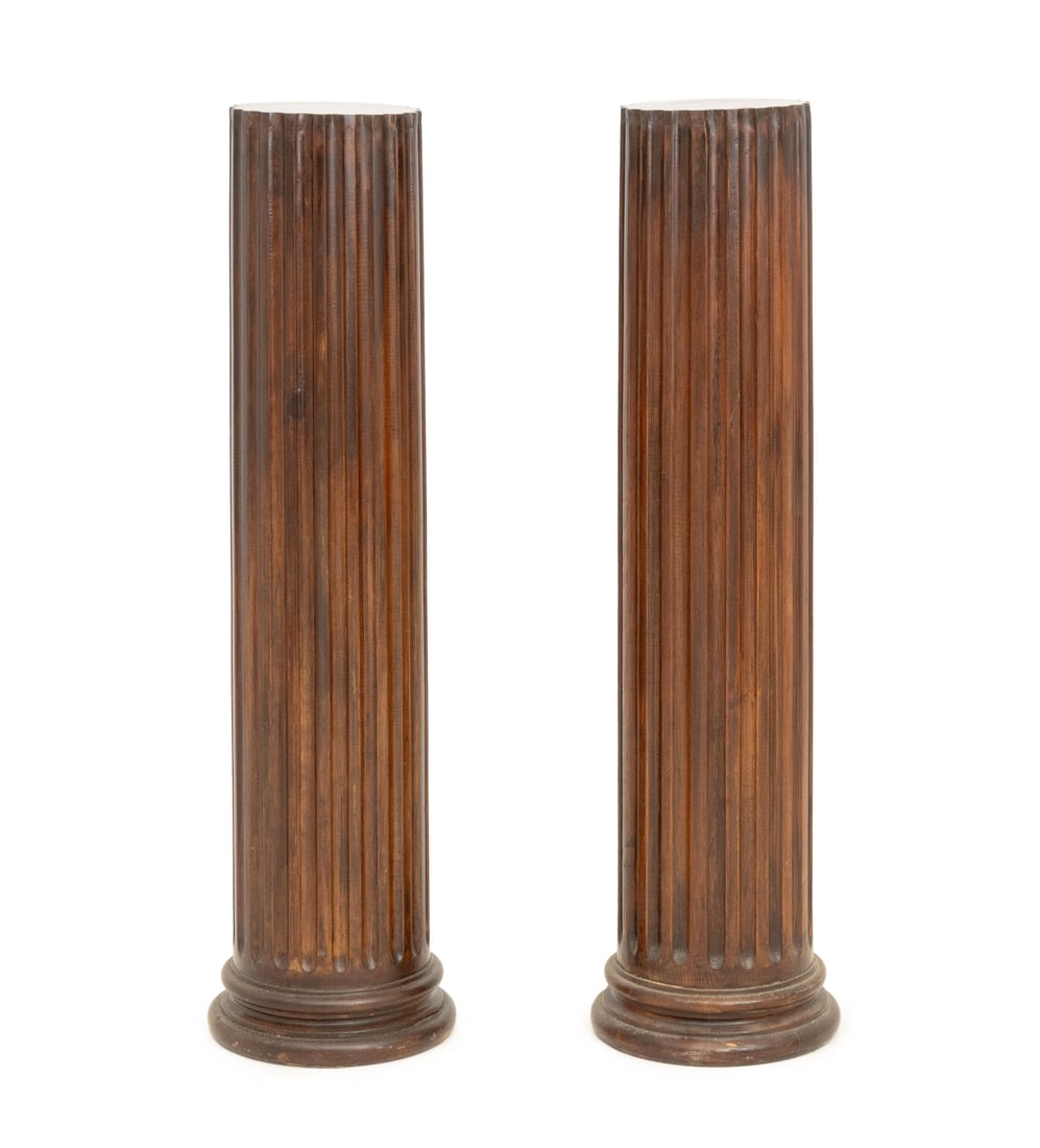 Neoclassical Style Mahogany Display Pedestals, 2: Pair of Neoclassical Style Fluted Mahogany Display Pedestals. 49.75" H x 13" Diameter. Provenance: From a West End Avenue Collection. Keywords: Vintage Furniture, Display stand, Plinth, Base, Sculptur