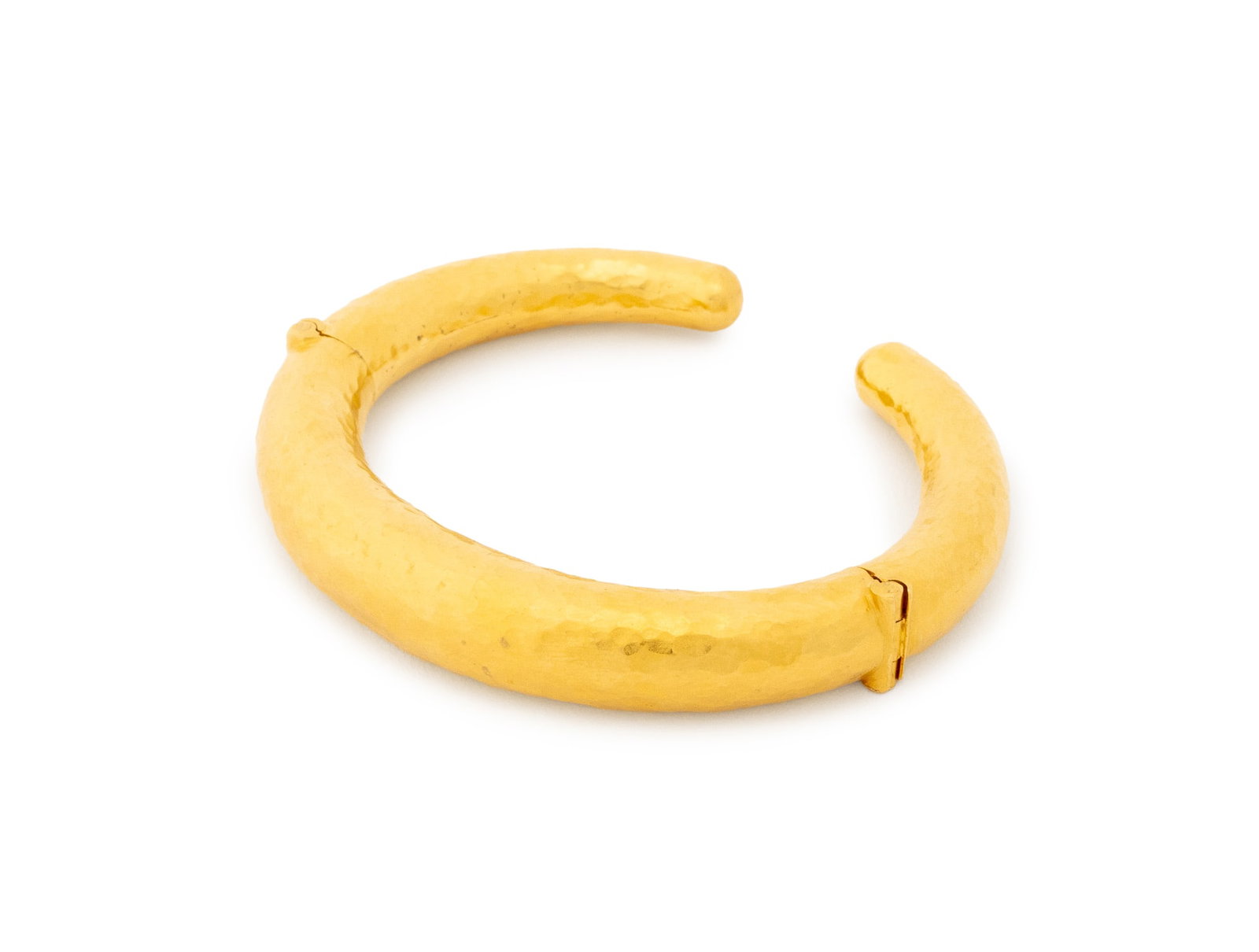 Hilat 22K Yellow Gold Torque Bangle: Hilat 22K Yellow Gold Torque Bangle, featuring hammered and brightly polished finish, worn as a cuff bangle with spring hinged terminations, marked: "HILAT 1999 22CT". Measuring approx. 6 1/2" x 3/8" 