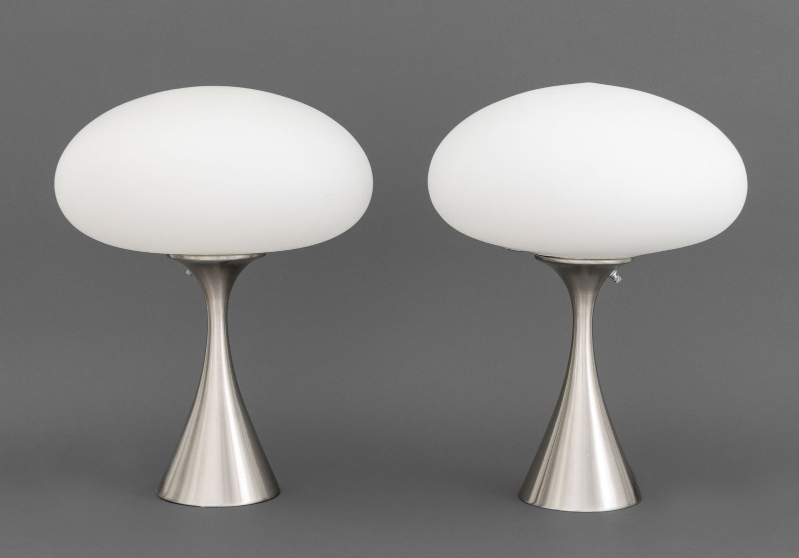 Laurel Mushroom Table Lamps, Pair: Pair of Laurel Mid-Century Modern Mushroom Table Lamps, each with frosted white glass shade above an hourglass form chrome-plated base. 17.5" H x 13" Diameter. Provenance: From a 35 Sutton Place Estat