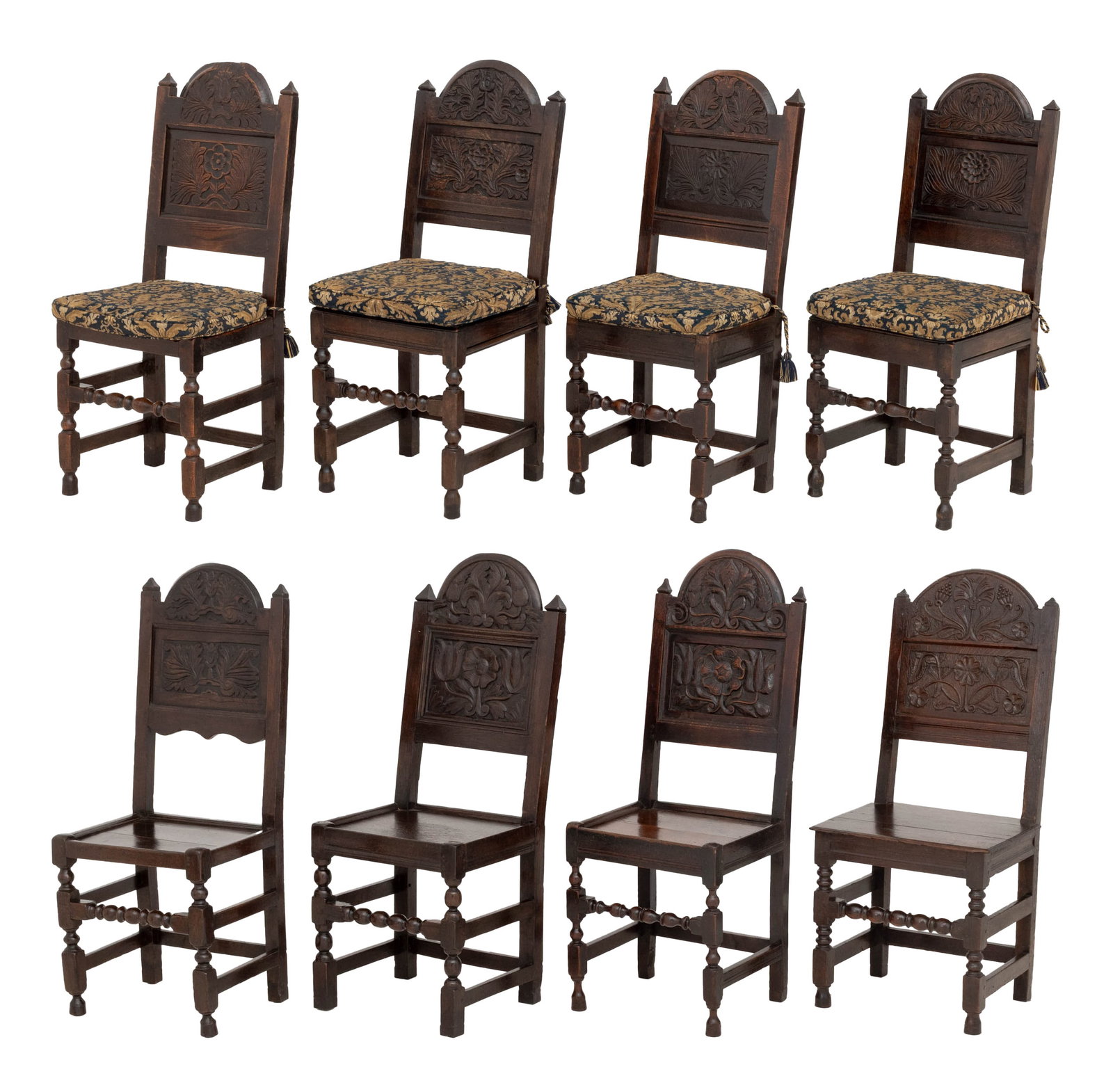 Jacobean Carved Oak Dining Chairs, 8: Set of Eight Jacobean Carved Oak Dining Chairs, late 17th century with later modifications, various floral motif carved back panels and blue and golden upholstered cushions above various box