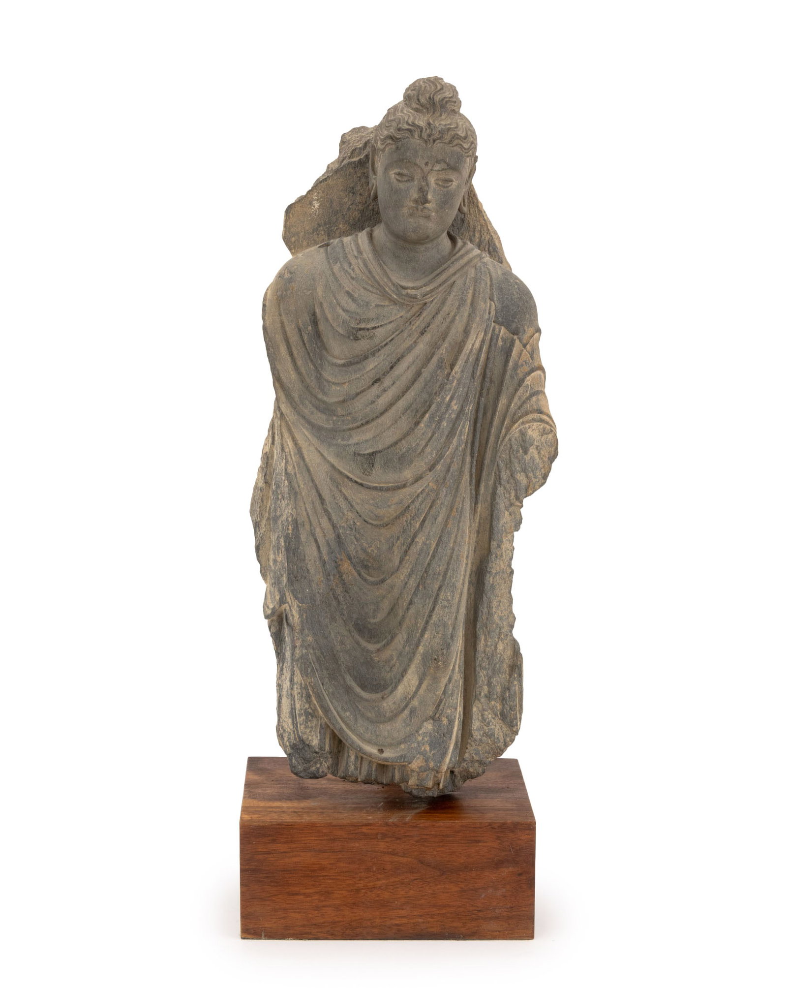 Gandhara Gray Schist Standing Buddha Sculpture: Gandharan Carved Gray Schist Standing Buddha Sculpture, mounted on a wood base. Overall: 28.5" H x 10.5" W x 8" D. Provenance: Collected 1970s. From an East 57th Street Estate. Keywords: Greco-Gandhar