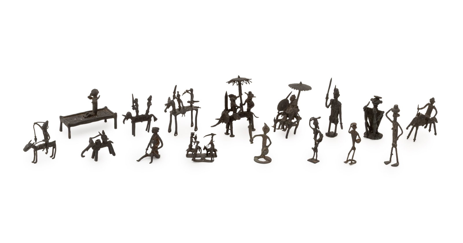 Collection of Indian Dhokra Bronze Figures, 16: Collection of Sixteen Indian Dhokra Bronze Figures, including mounted horse riders, a figure seated on a charpoy, figures riding elephants, and warriors. Tallest: 3.5" H x 3.75" W x 1.5" D. Provenance