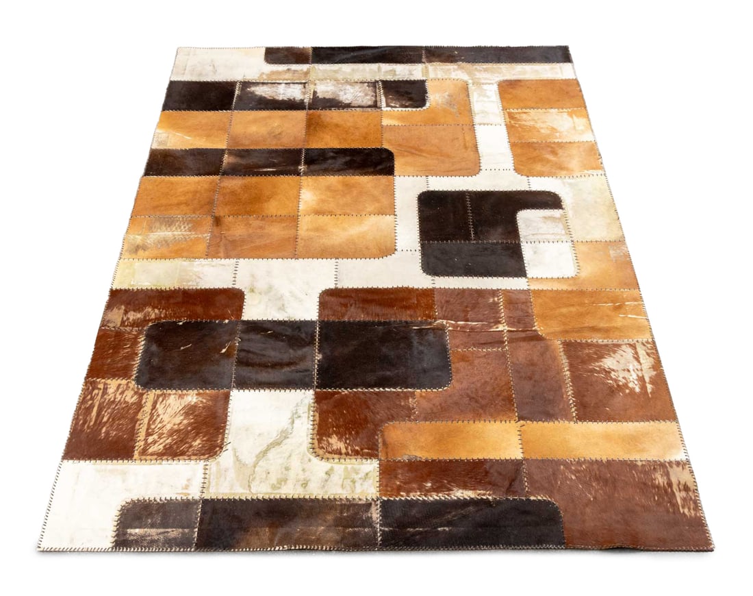 Cowhide Patchwork Carpet, 9' 8" x 6' 9": Cowhide Patchwork Carpet, with leather stitching in brown, black, and white. 9' 8" L x 6' 9" W. Provenance: From a 320 Central Park West Collection. Keywords: Rugs, Area rug, Floor covering, Animal hi