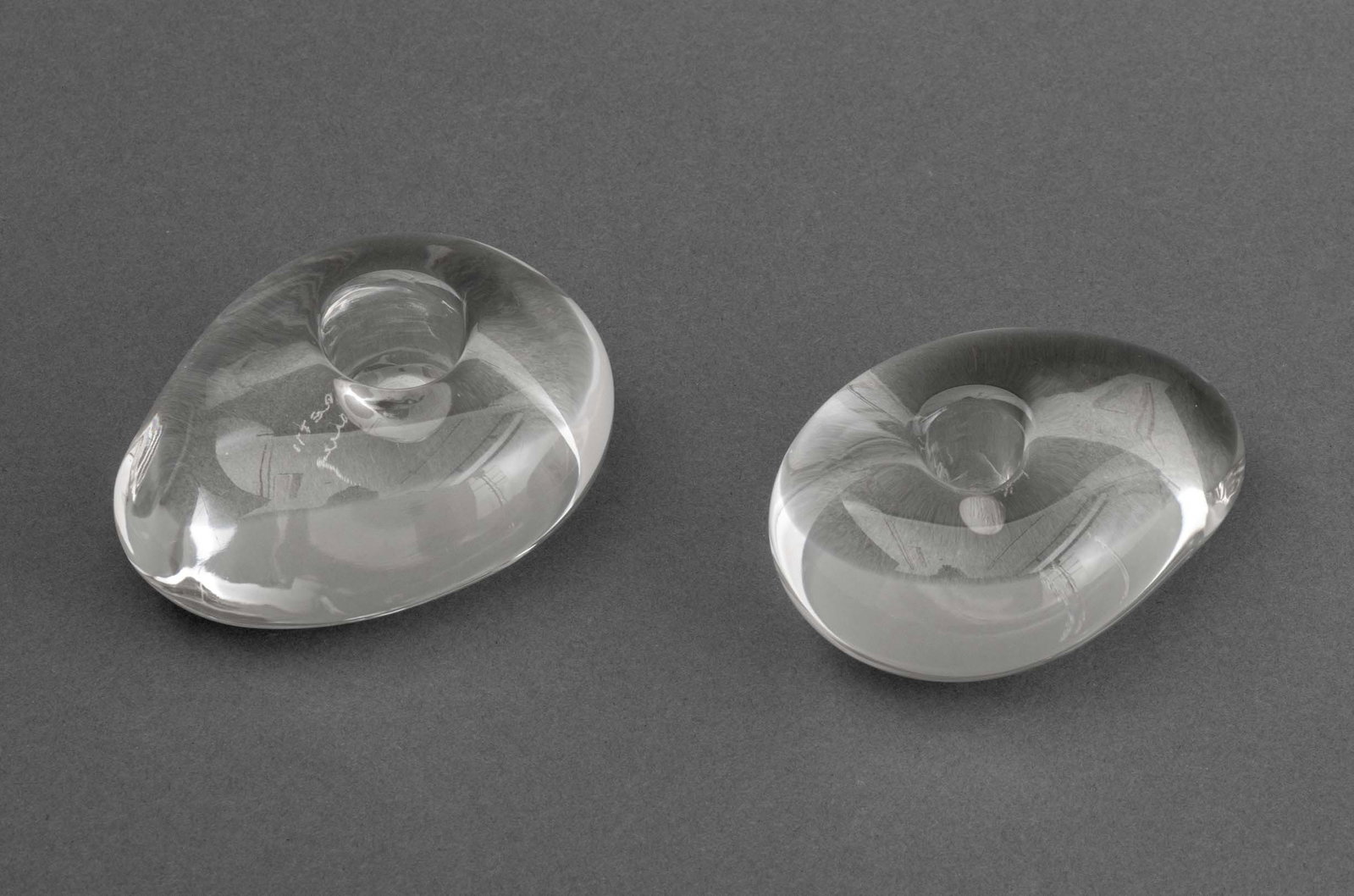 Elsa Peretti for Tiffany & Co. Candleholders, Pair: Pair of Elsa Peretti (Italian, 1940-2021) for Tiffany and Company Glass Candleholders, each signed and marked "Elsa Peretti for Tiffany" to underside. 2" H x 4" W x 3" D. Provenance: From an Upper Wes