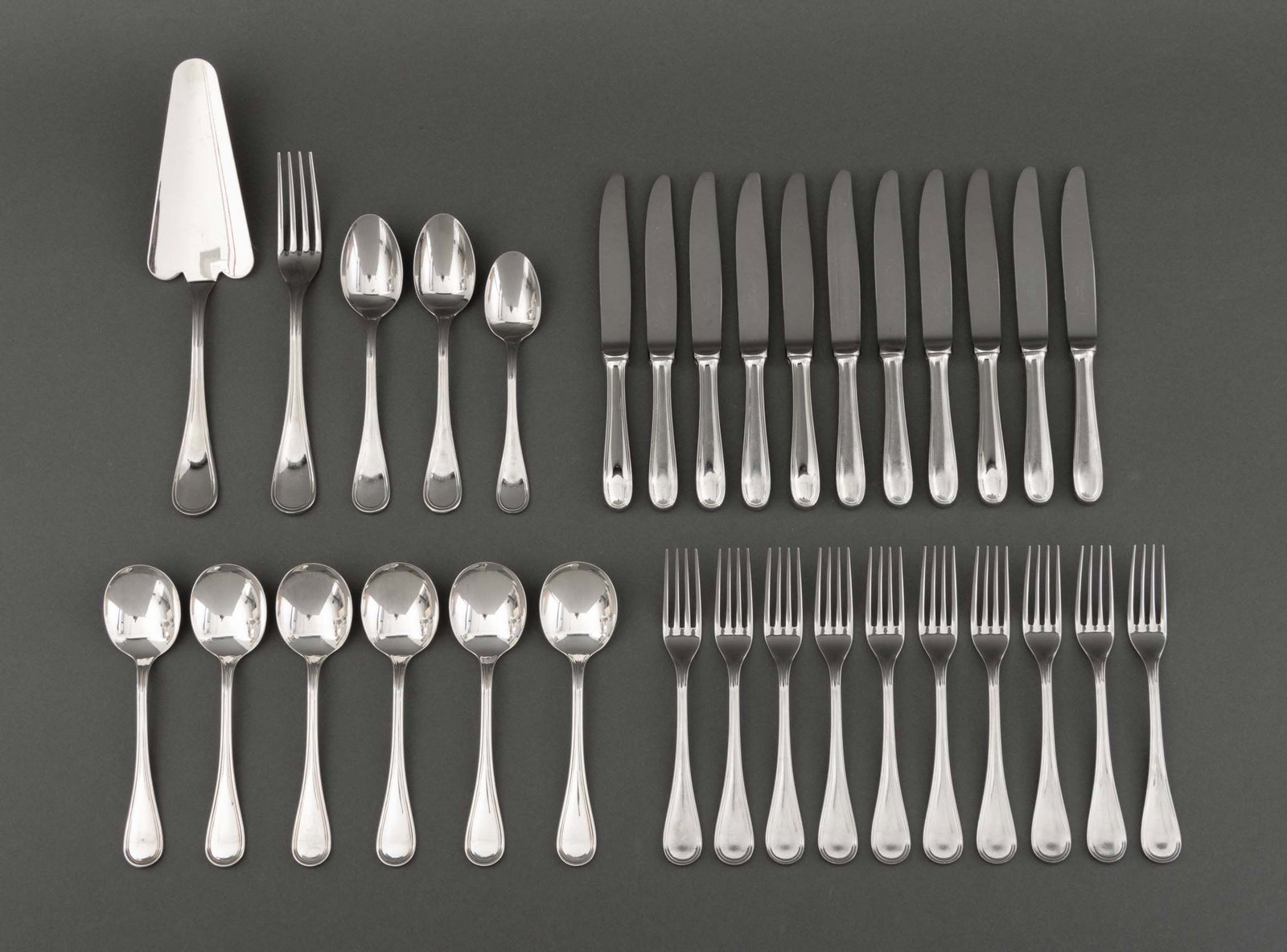 Christofle "Acier" Part Flatware Service, 32 Pcs.: Christofle "Acier" Partial Flatware Service, each marked and comprising: (1) cake server, (11) butter knives, (2) tablespoons, (1) teaspoon, (6) silver plate soup spoons, and (11) forks. Thirty-two