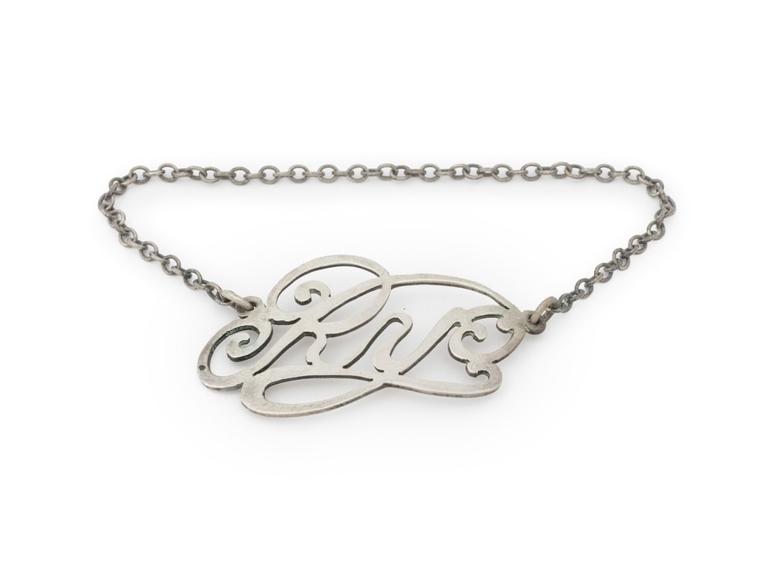 Cartier Sterling Silver "Rye" Bottle Label: Cartier Sterling Silver "Rye" Bottle Label, marked "CR / Sterling / 8 / Cartier" to reverse. Weight: 0.22 ozt.; 4" L x 1.75" W. Provenance: From a New York City Collection. Keywords: French designer, 