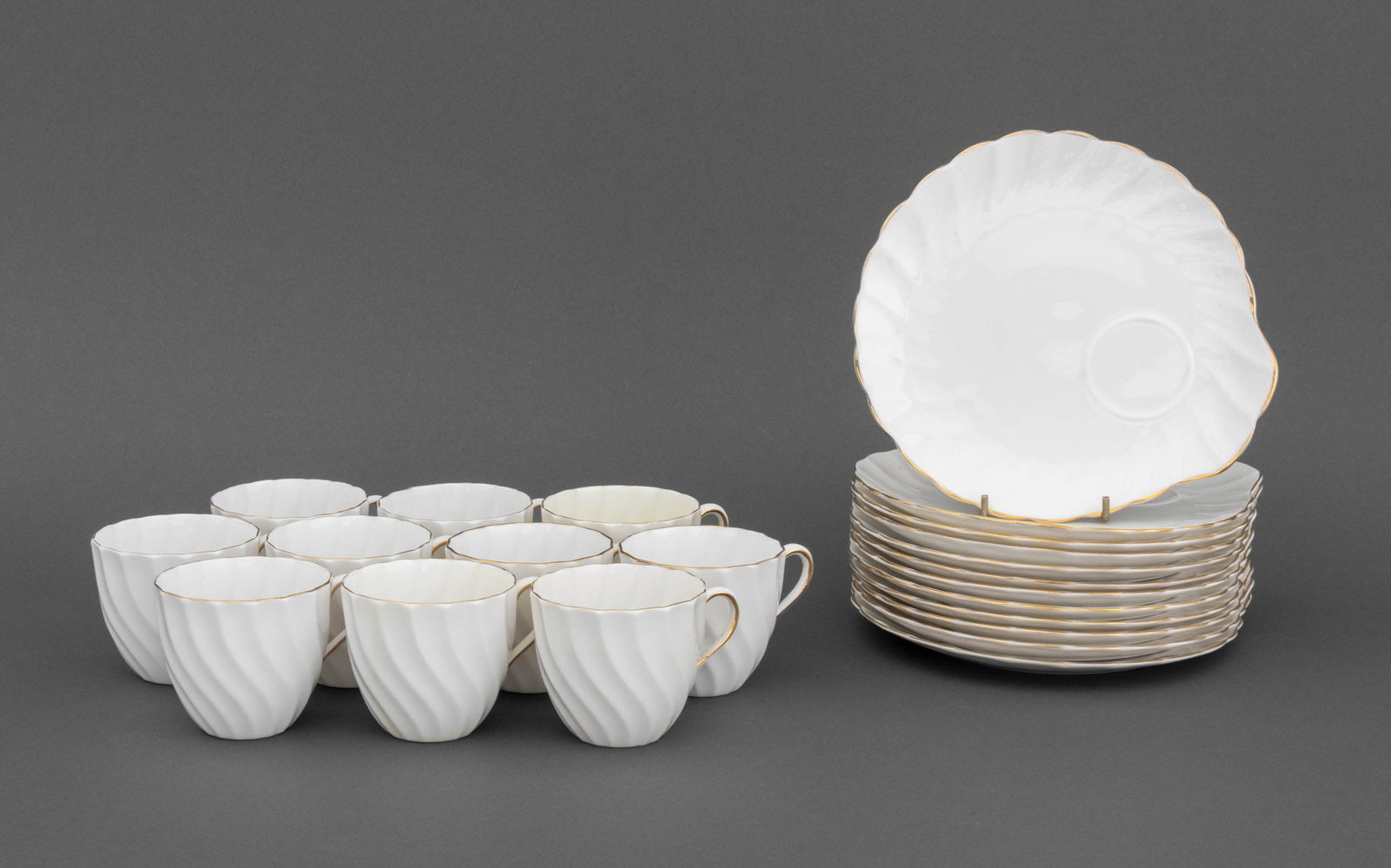 Royal Tuscan "Dover" Bone China Service, 22 Pcs.: Royal Tuscan "Dover" Pattern Bone China Partial Tea Service, comprising: ten (10) teacups and twelve (12) shell form snack plates, each marked "Tuscan / Fine English / Bone China / Made in / England" 