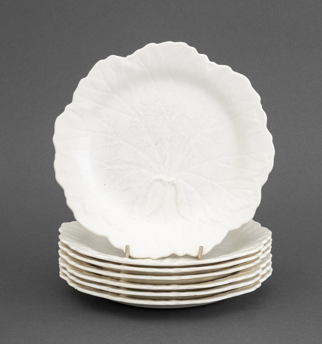 Wedgwood White Cabbage Leaf Plates, 7: Set of Seven Wedgwood of Etruria and Barlaston Cabbage Leaf Form White Glazed Ceramic Plates, marked "Wedgwood of Etruria & Barlaston / Made in England" and impressed "Wedgwood" mark to underside. 7.7