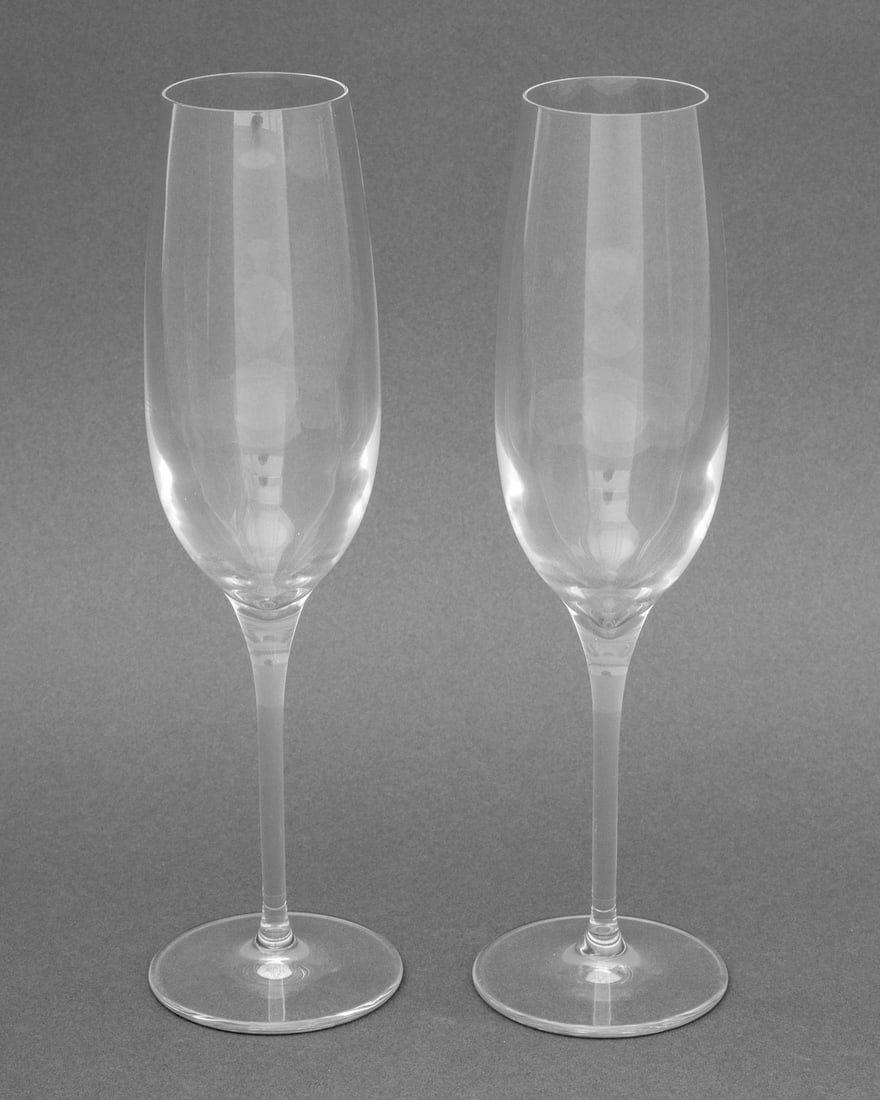 Tiffany & Co. Crystal Champagne Flutes, Pair: Pair of Tiffany and Company Crystal Champagne Flutes, etch marked "Tiffany & Co." to undersides. 9.5" H x 2.75" Diameter. Provenance: From an East 86th Street Estate. Keywords: T&Co., Designer, Stemwa