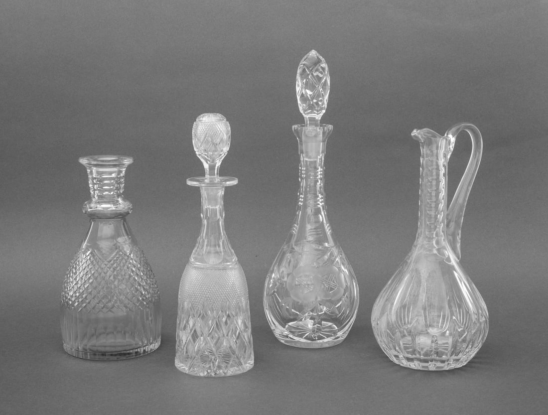 Collection of Cut Crystal Decanters, 4: Collection of Four Cut Crystal Decanters, one a ewer. Tallest: 14.5" H x 4.75" Diameter. Provenance: From a New York City Collection. Keywords: Bottles, Drinkware, Tableware, Barware, Oenology, Glassw