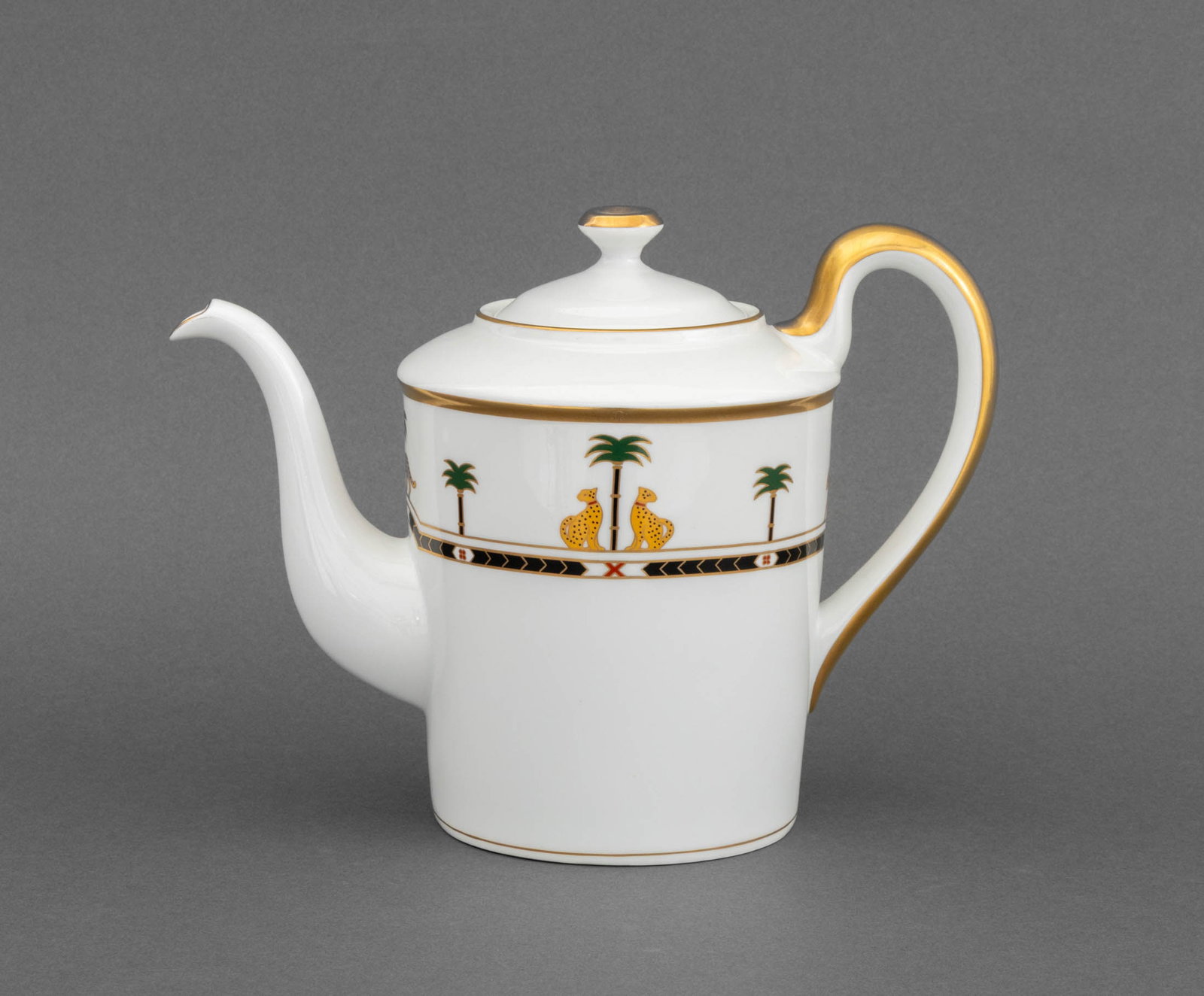Christian Dior "Casablanca" Porcelain Teapot: Christian Dior "Casablanca" Porcelain Tea Pot, with gilt decorated handle, leopard and palm tree motif, marked to underside. 7.75" H x 10.5" W x 5.75" D. Provenance: From a TriBeca Estate. Keywords: F