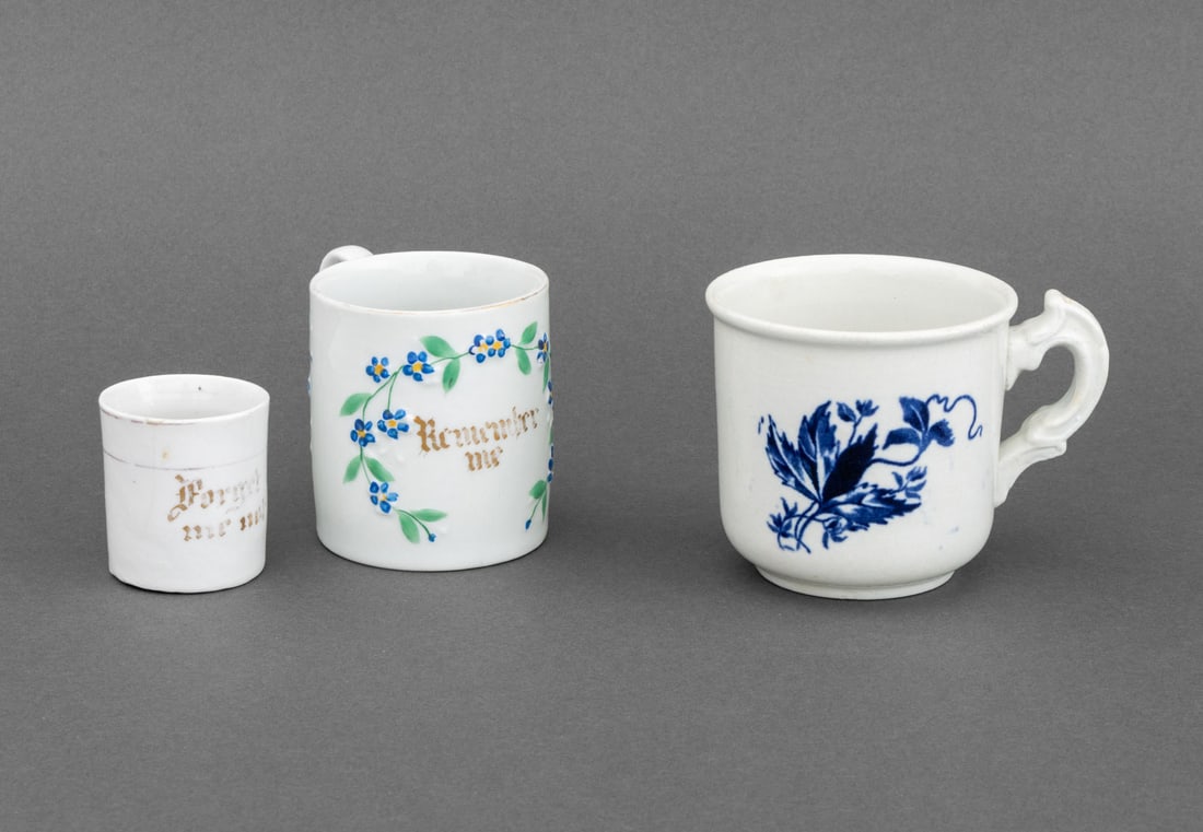 Victorian Remembrance Porcelain Cups, 3: Collection of Three Victorian Remembrance Cups, one with gilt "Forget me not" and one "Remember me", the third with cobalt blue floral motif. Largest: 3.5" H x 5" W x 3.5" D. Provenance: From a 21 Eas