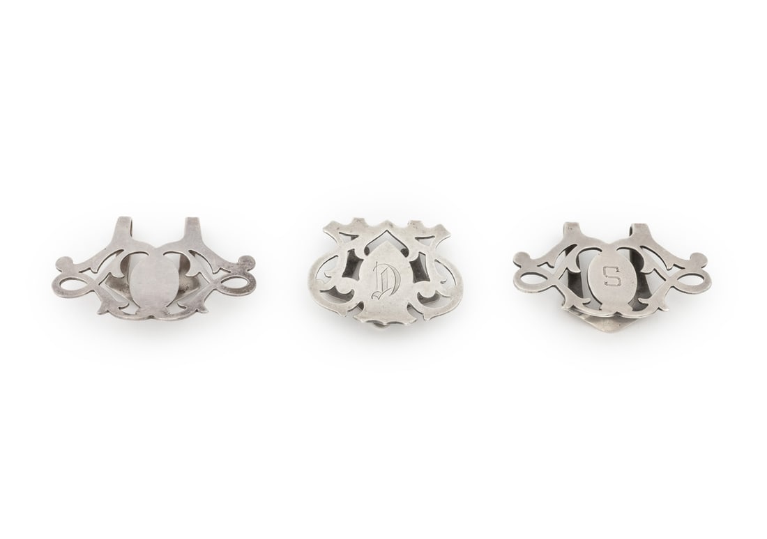 Art Deco Sterling Silver Napkin Holders, 3: Group of Three Art Deco Sterling Silver Napkin Holders, marked for Lunts Silversmiths, with pierced scroll and foliate design, marked to verso. Weight: 1.06 ozt.; larger: 1.5" L x 2" W. Provenance: Fr