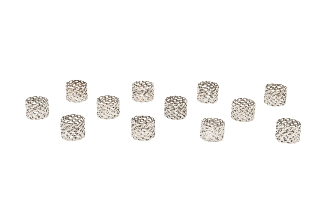 Modern Woven Silver Plate Napkin Rings, 12: Set of 12 Modern Woven Silver Plate Napkin Rings. 1.5" H x 2" Diameter. Provenance: From the Fifth Avenue Estate of a Distinguished Author and Humanitarian. Keywords: Silversmith, Place setting, Table