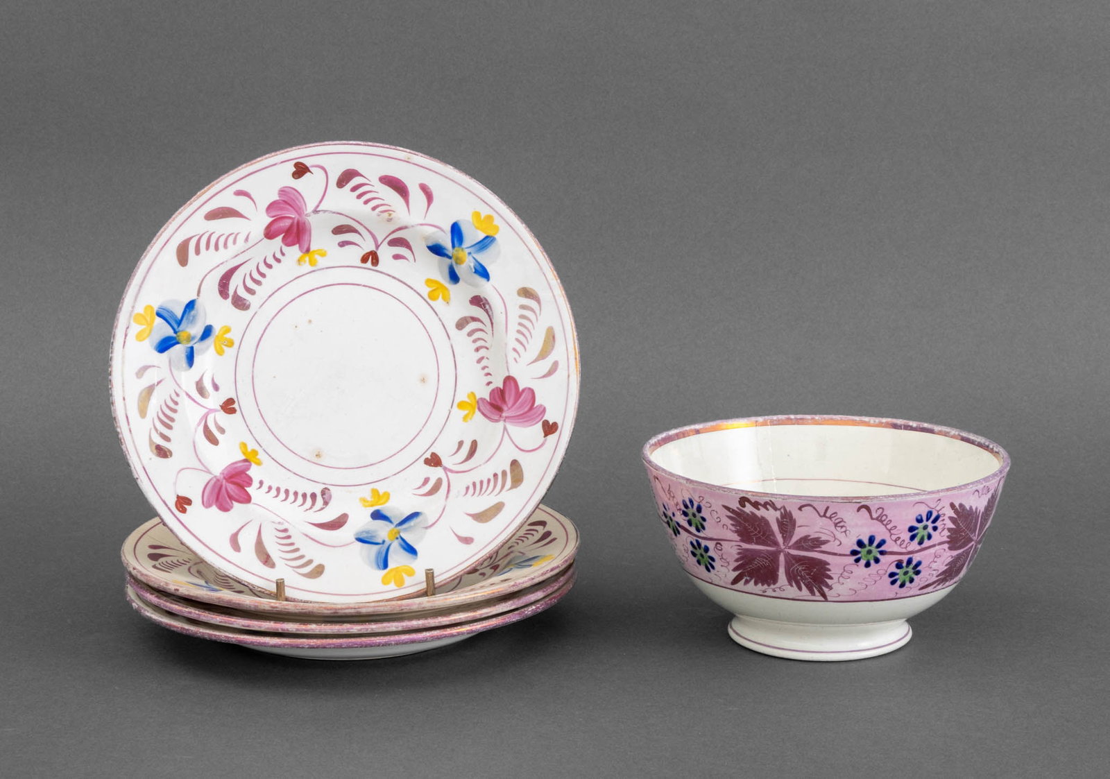 French Faience and Lustreware Tableware, 5 Pcs.: Group of Five French Faience and Lusterware Tableware Pieces, comprising: (4) four plates with painted flower and pink iridescent rim and (1) one bowl with pink iridescent floral band motif, unmarked.