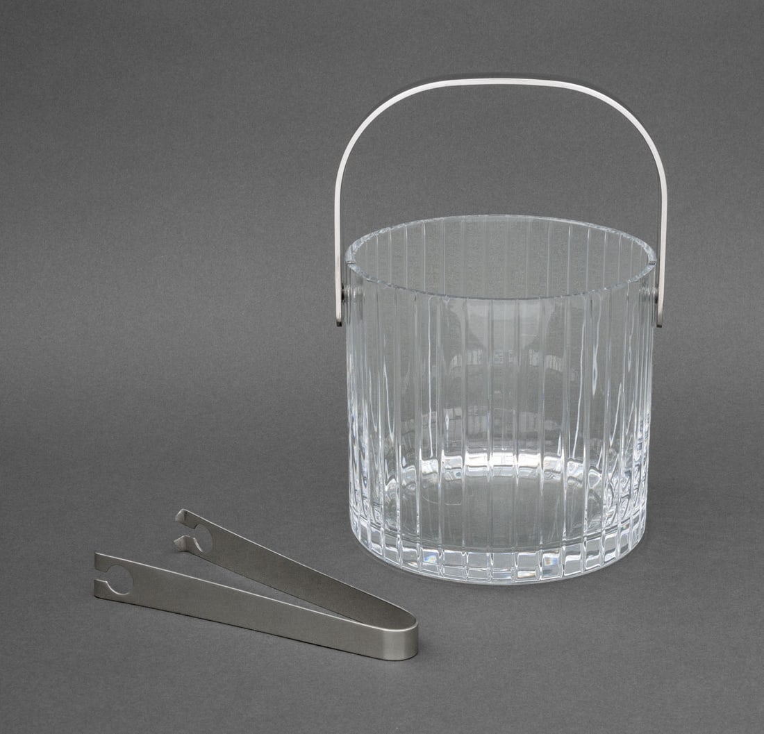 Modernist Glass and Stainless Steel Ice Bucket: Modernist Glass and Stainless Steel Ice Bucket, fluted cut glass with stainless steel handle and tongs. 5.5" H x 6" Diameter. Provenance: From an East 86th Street Estate. Keywords: Barware, Ice pail, 