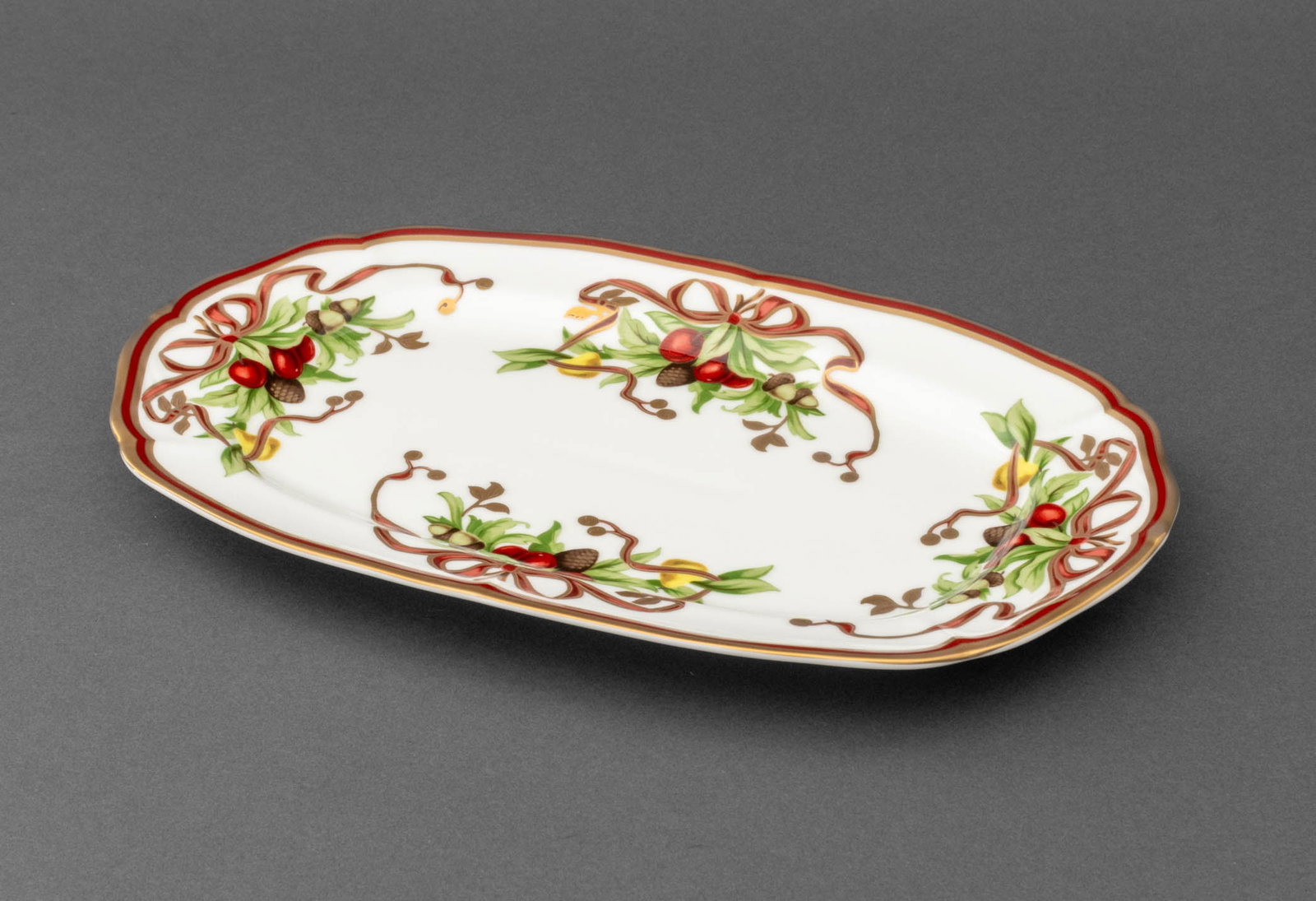Tiffany & Co. "Tiffany Holiday" Porcelain Platter: Tiffany and Compan "Tiffany Holiday" Porcelain Platter, with acorn and ribbon design, marked to underside. 12.25" L x 7.5" W. Provenance: The Estate of Alton G. Marshall, former aide to Nelson Rockefe