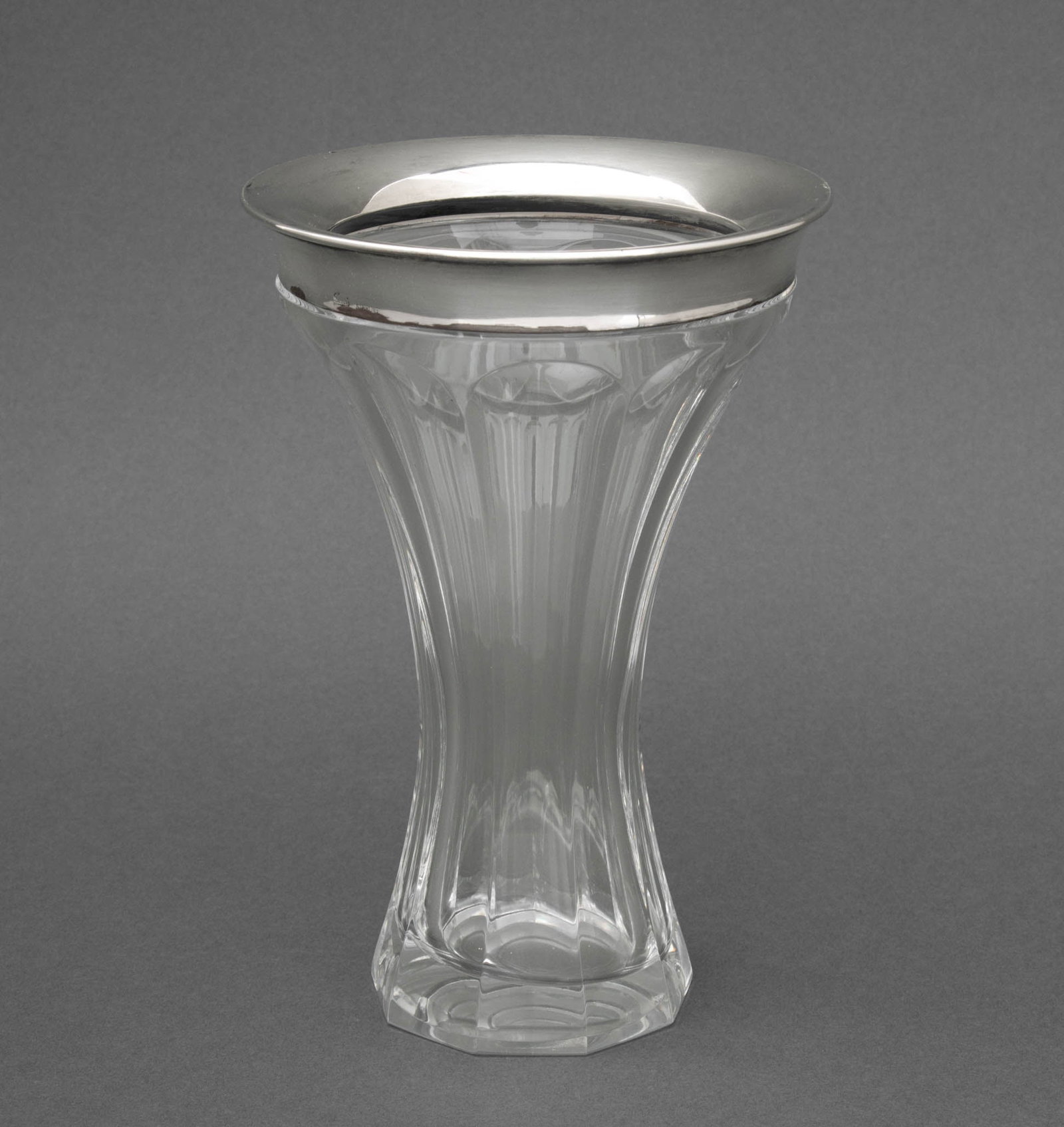 Gucci Sterling Silver Mounted Clear Glass Vase: Gucci Sterling Silver Mounted Clear Glass Vase, marked "Gucci / Sterling" to the rim. Silver not weighable. 8.25" H x 5.5" Diameter. Provenance: From a 35 Sutton Place Estate. Keywords: Italian